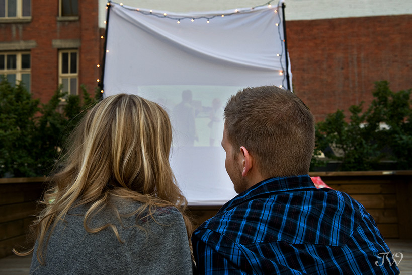 Rooftop-movie-Calgary-engagement-session-couple-watching-movie