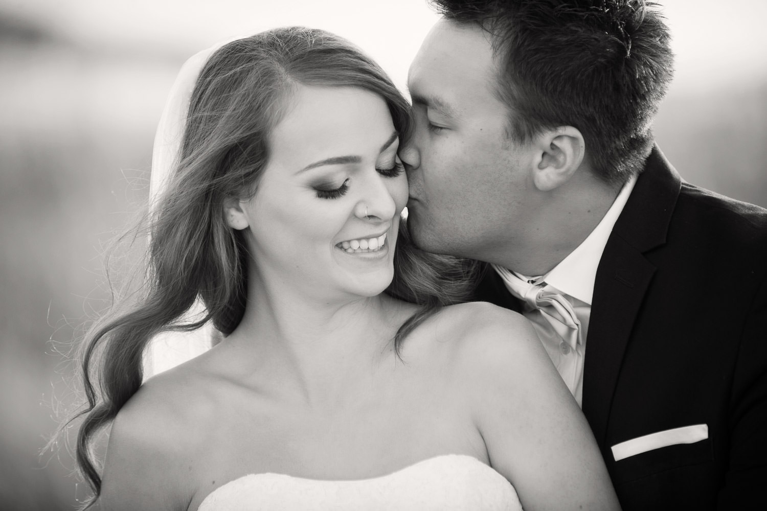 kiss on the cheek from the groom captured by Tara Whittaker Photography
