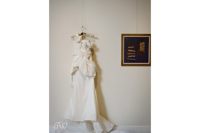 vera wang bridal gown hanging in an art gallery Tara Whittaker Photography