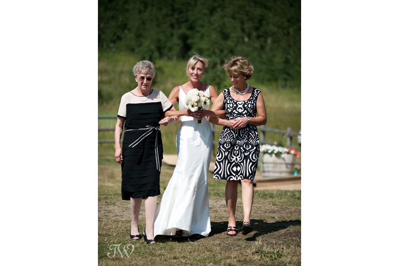 Mother of the bride walks her daughter down the aisle