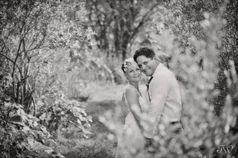 bride and groom pose in the trees
