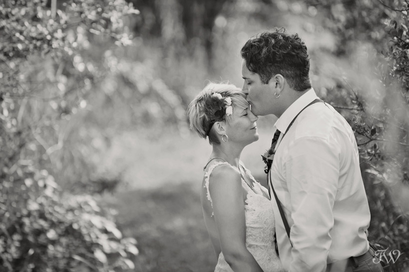 bride and groom embrace at their Okotoks ranch wedding captured by Tara Whittaker Photography