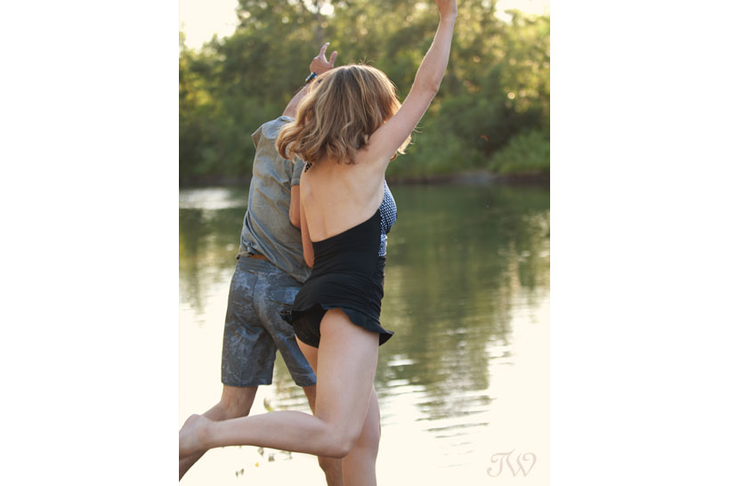 couple jumps into a swimming hole captured by Tara Whittaker Photography