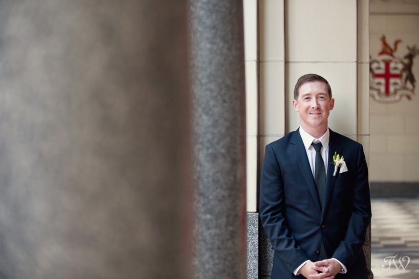 Groom poses on Stephen Avenue captured by Tara Whittaker Photography