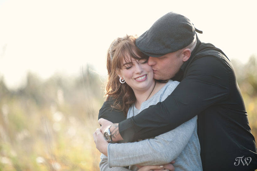 couple snuggle up during their fall engagement photos with Tara Whittaker Photography