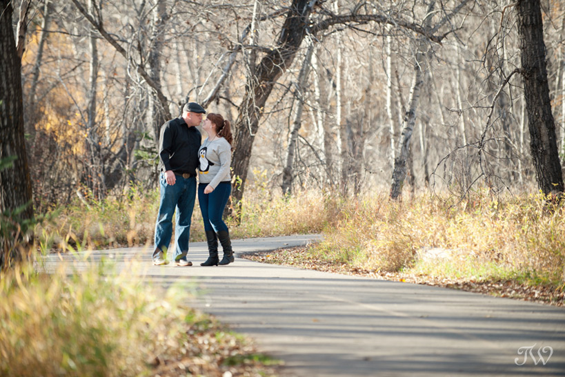 couple on a pathway in Fish Creek Park captured by Tara Whittaker Photography