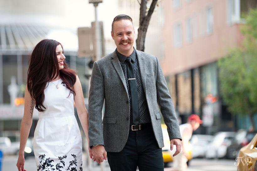 couple stroll in downtown Calgary captured by Tara Whittaker Photography