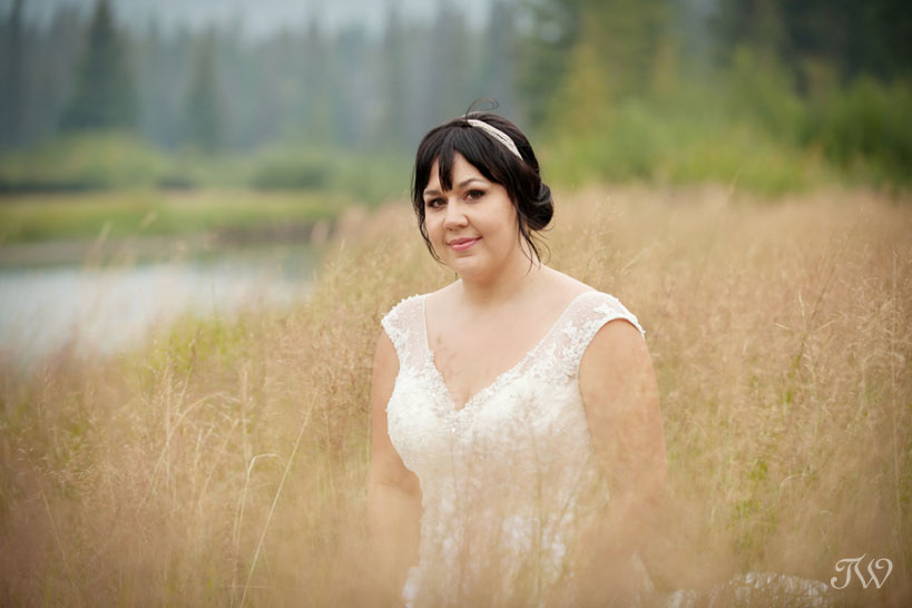 bride near the Bow River in Banff captured by Tara Whittaker Photography