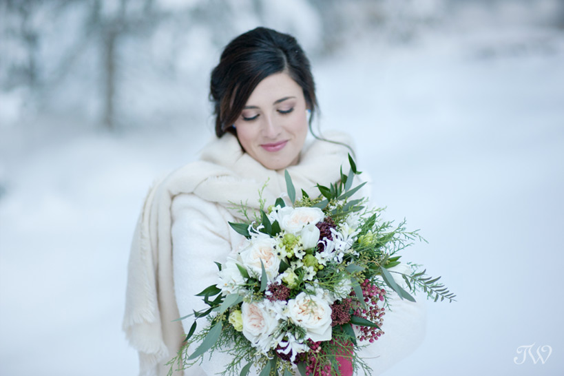 winter bride carrying her bouquet captured by Tara Whittaker Photography