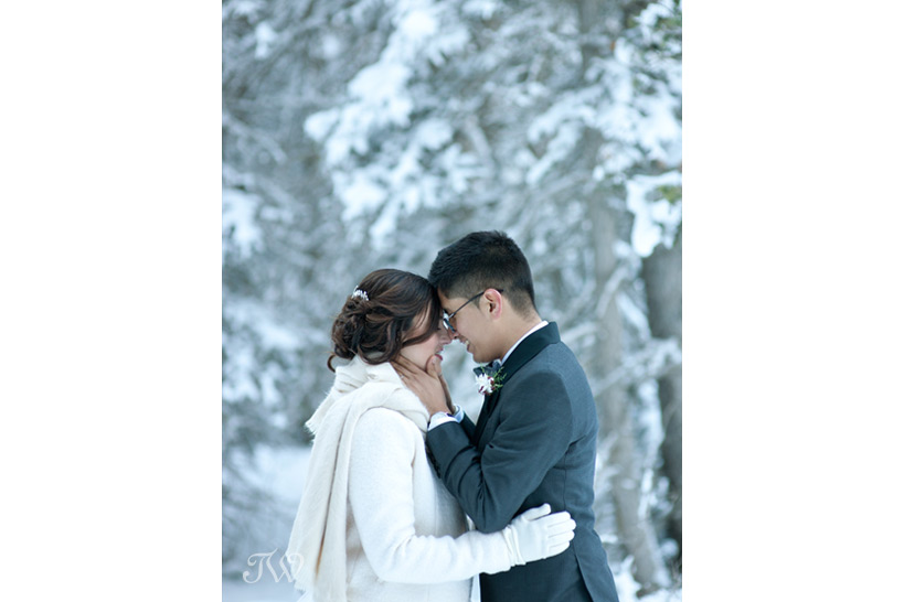 bride and groom embrace at their winter wedding captured by Tara Whittaker Photography