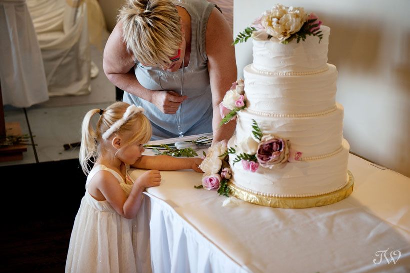Cakeworks putting the final touches on a wedding cake captured by Tara Whittaker Photography