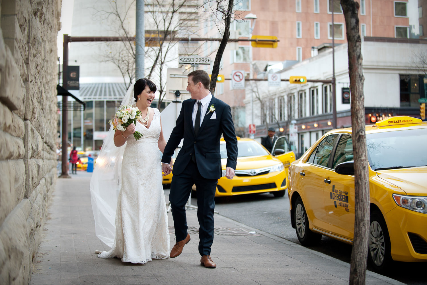 bride and groom on Stephen Avenue captured by Tara Whittaker Photography