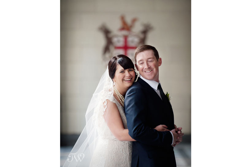 happy bride and groom on Stephen Avenue captured by Calgary wedding photographer Tara Whittaker