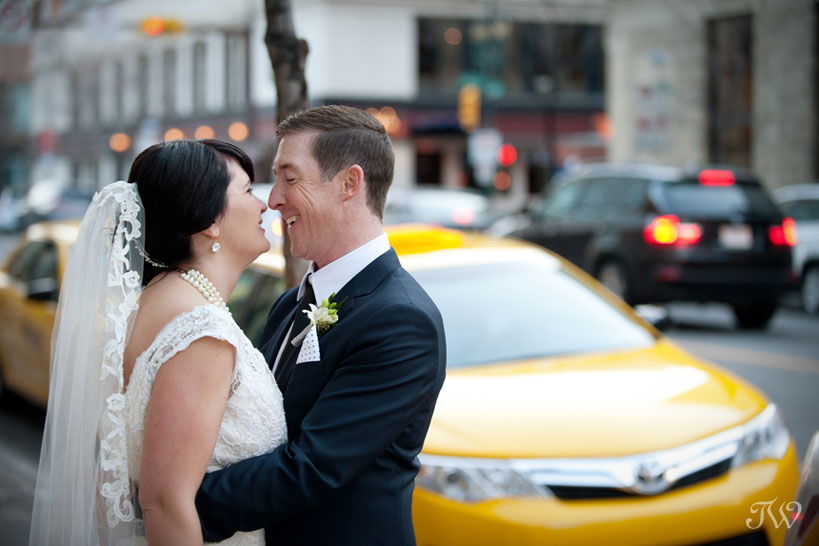 Bride and groom embrace on Stephen Avenue in Calgary captured by Tara Whittaker Photography