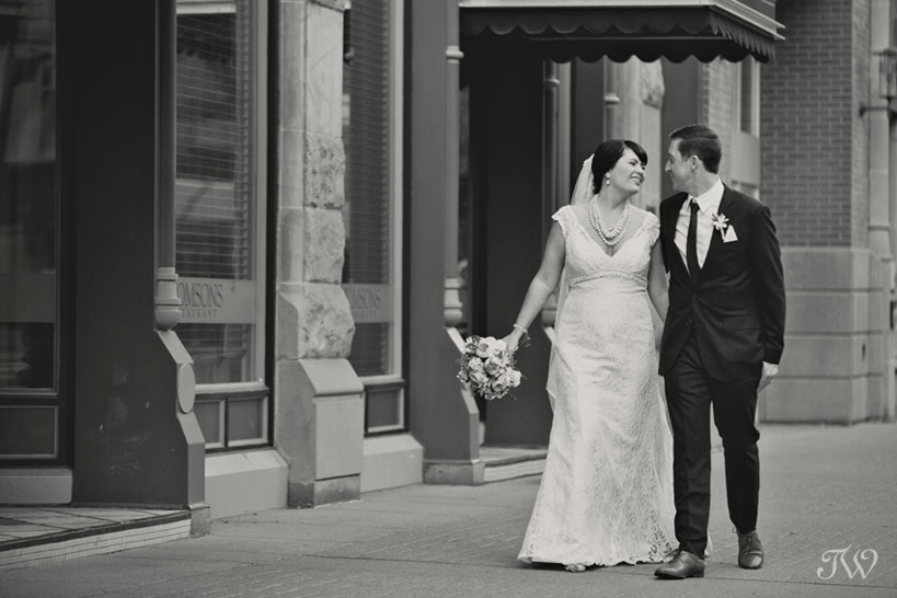 bride and groom take a stroll on Stephen Avenue captured by Tara Whittaker Photography