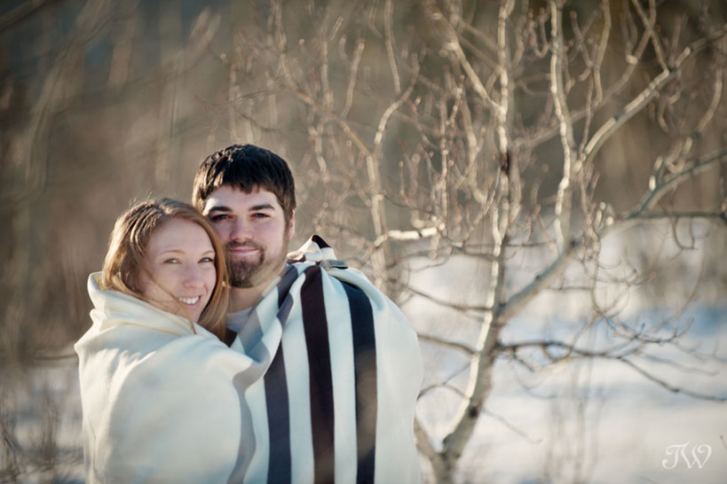couple in a Hudson Bay Blanket during their winter engagement session