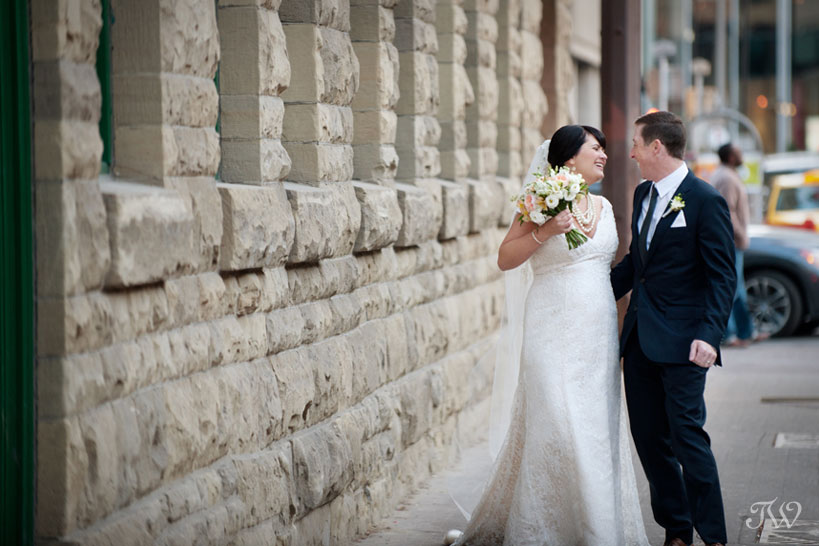 bride & groom on Stephen Avenue captured by Calgary wedding photographer Tara Whittaker