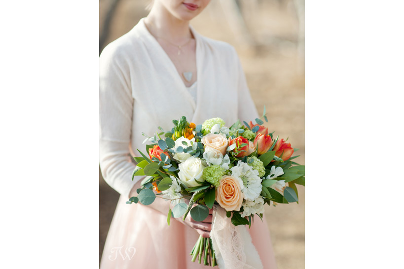 brides carries a spring bouquet from Flowers by Janie captured by Tara Whittaker Photography