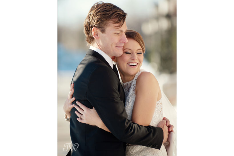 Happy bride and groom during their winter wedding photos captured by Tara Whittaker Photography