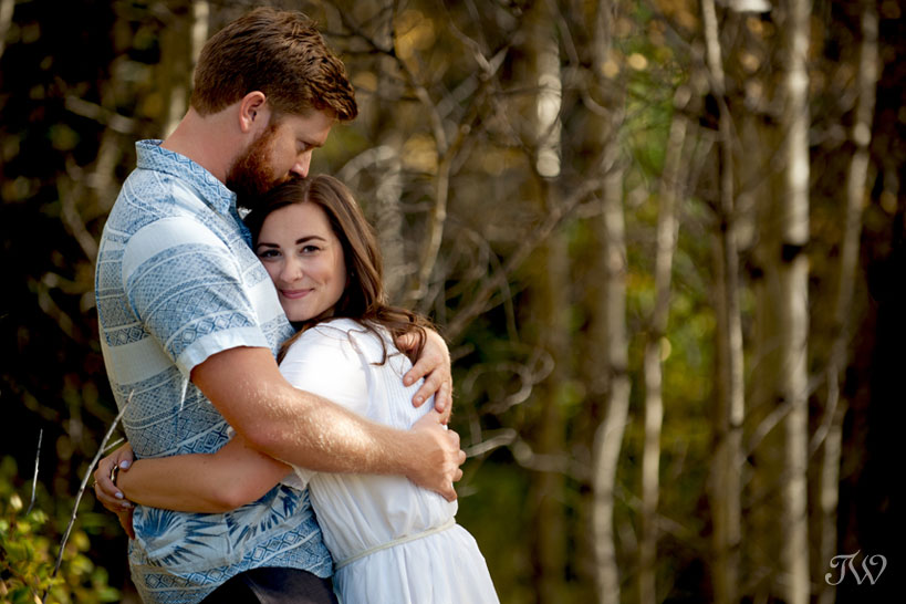 couple embrace during their fall engagement session captured by Tara Whittaker Photography