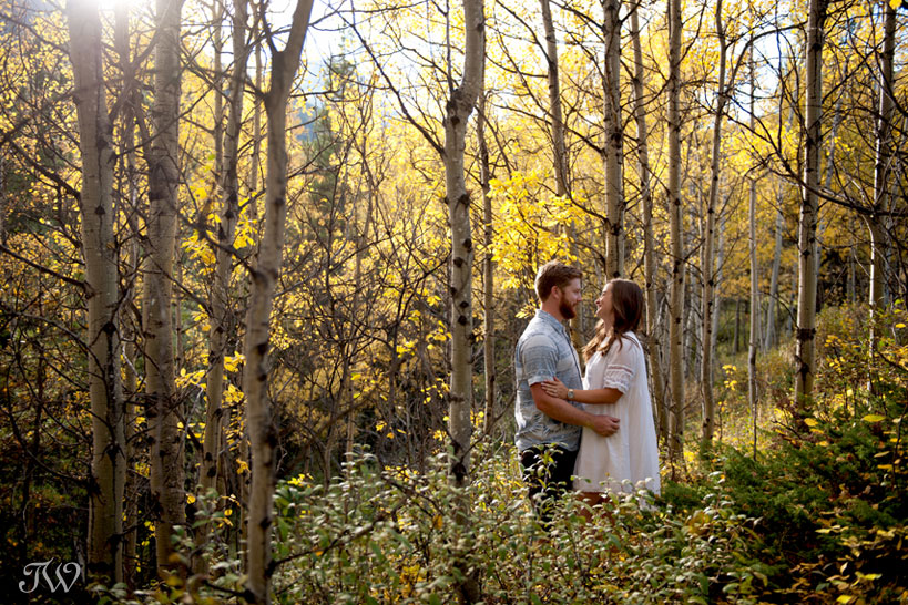 couple amongst the yellow trees during their fall engagement session