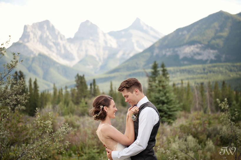 bride and groom in front of the Three Sisters in Canmore