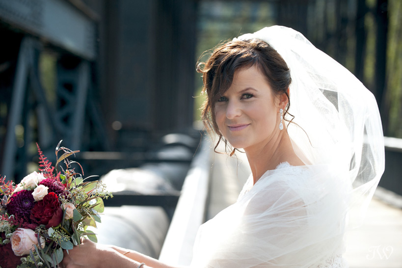 bride on the railway bridge in Canmore captured by Tara Whittaker Photography