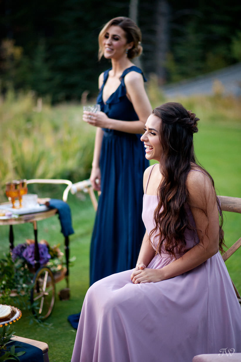 bridesmaids enjoy cocktails at a Silvertip wedding captured by Calgary wedding photographer Tara Whittaker