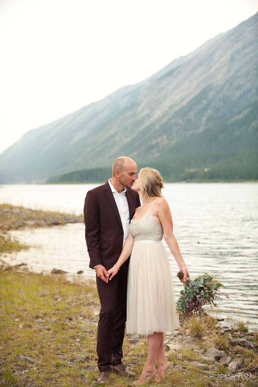 Caitie & Mark share a kiss at their Spray Lakes engagement session captured by Tara Whittaker Photography