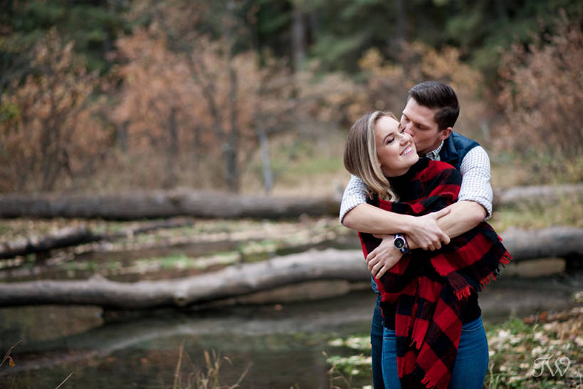 Couple embrace during their Big Hill Springs engagement session captured by Tara Whittaker Photography