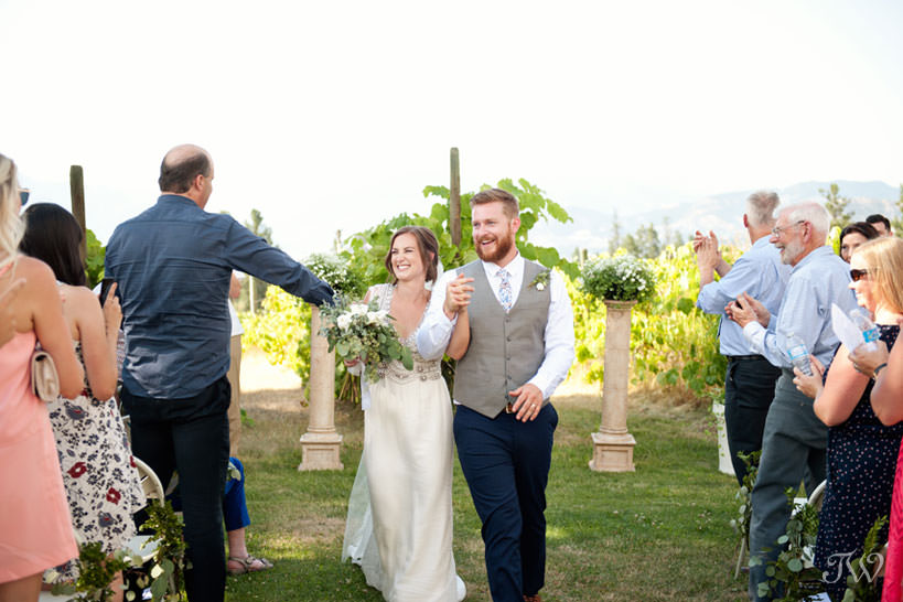 newlyweds during vineyard wedding ceremony in Kelowna captured by Tara Whittaker Photography