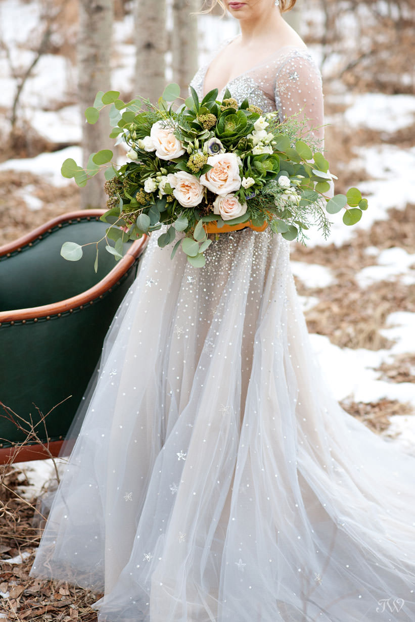 Winter Hayley Paige bride carries bouquet of greenery captured by Tara Whittaker Photography