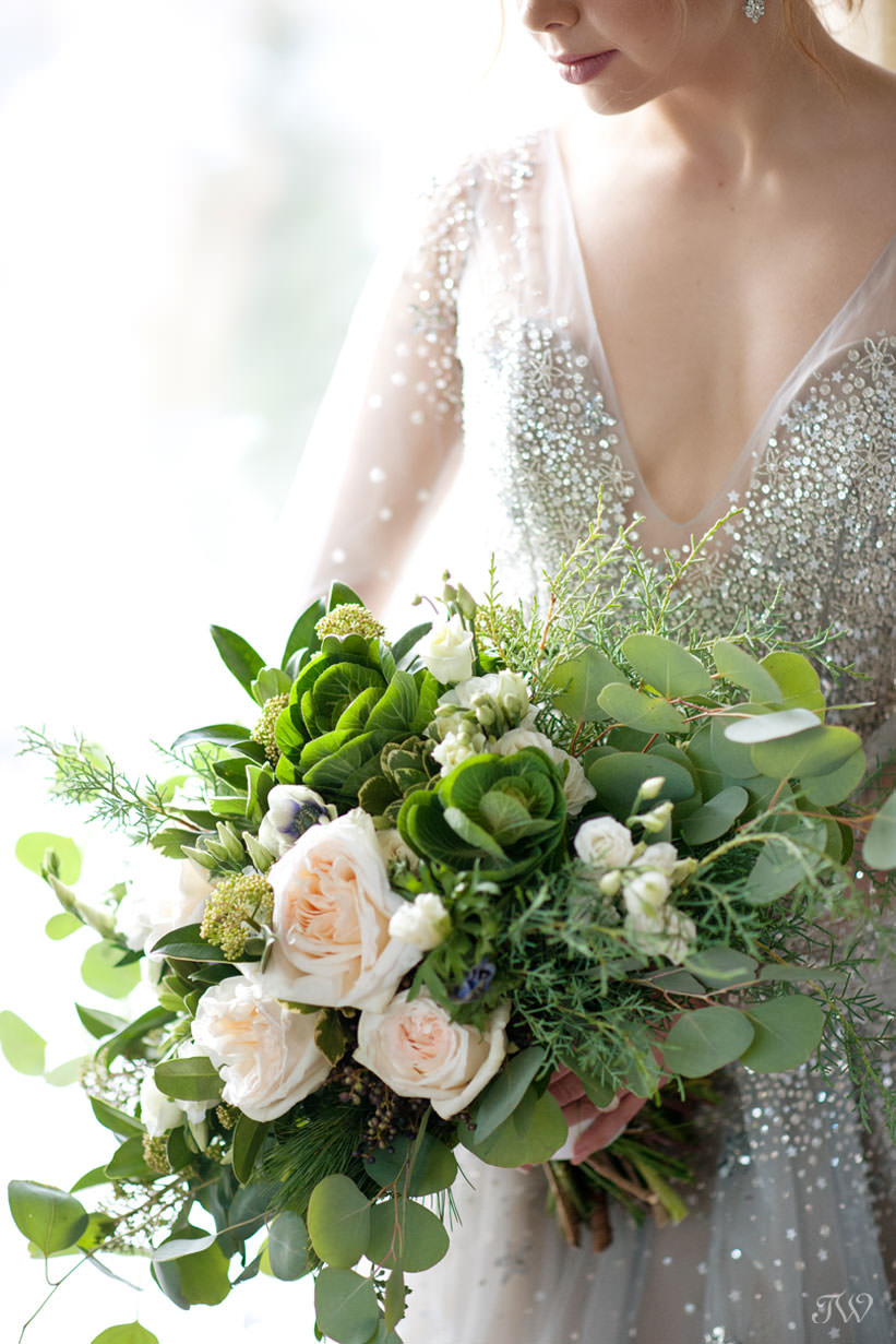 Winter Hayley Paige bride carries a bouquet from Fleurish Flower shop captured by Tara Whittaker Photography