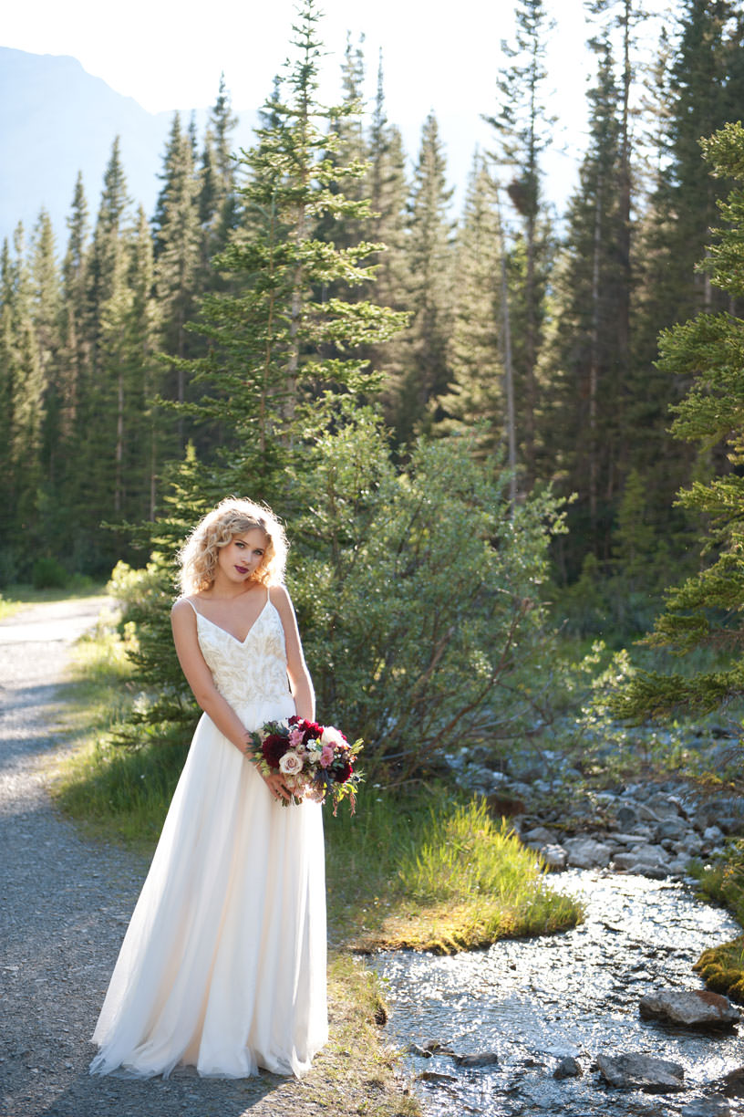 Bride poses for Canmore wedding photos with Tara Whittaker Photography