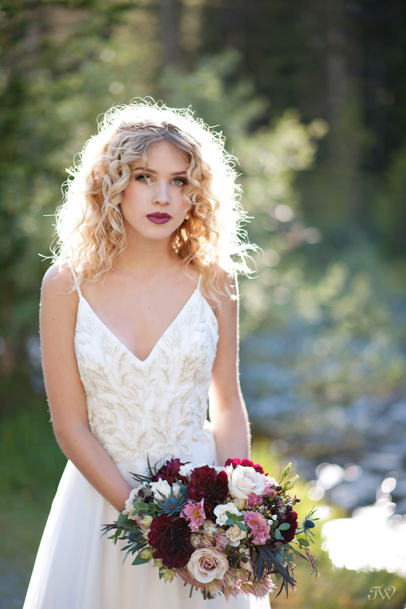 Bride poses for Canmore wedding photos with Tara Whittaker Photography
