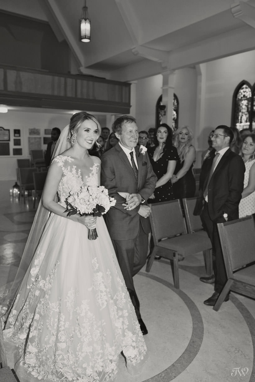 Bride walks down the aisle at St Stephen's Church captured by Calgary wedding photographer Tara Whittaker