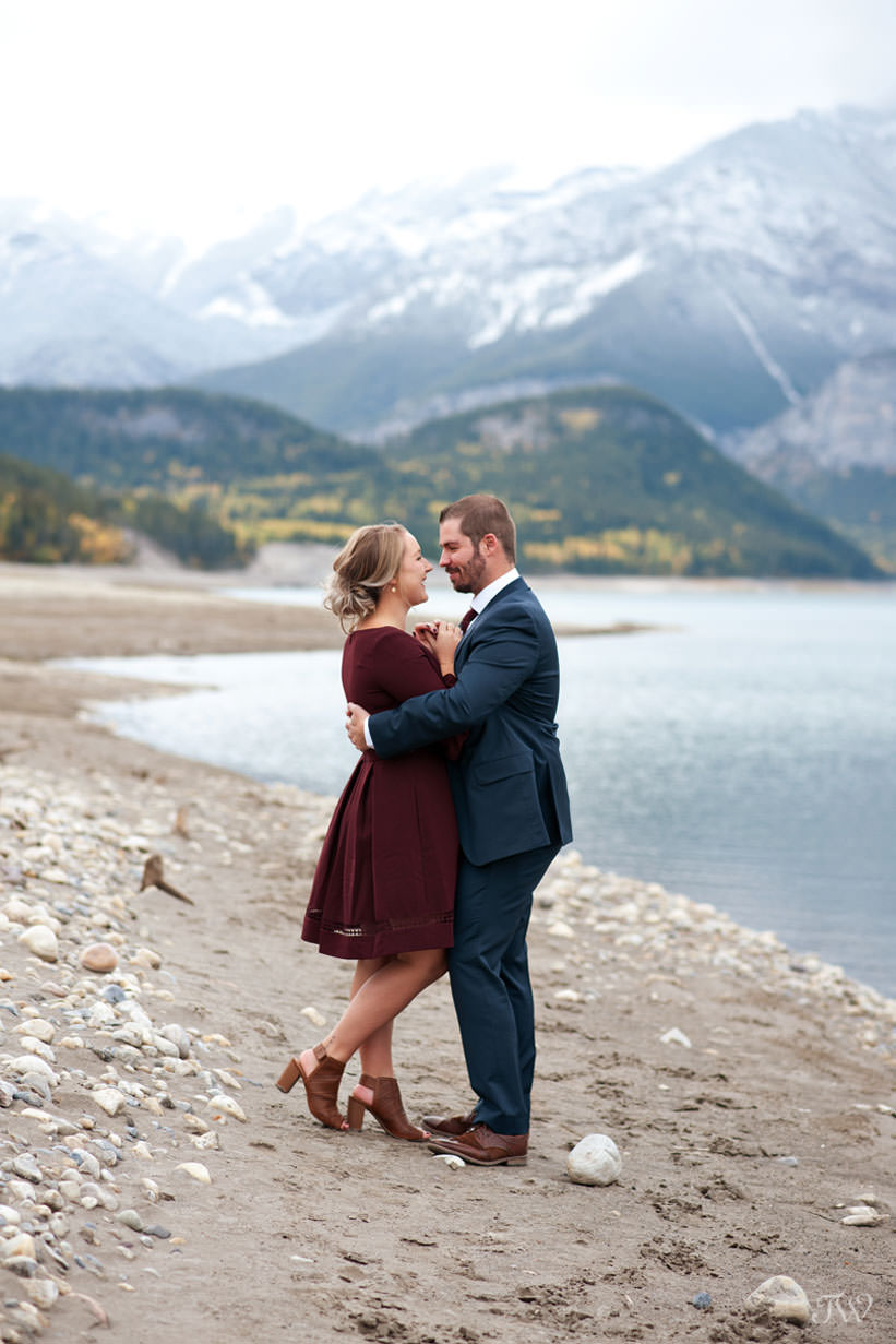 bride and groom on the shore of Barrier Lake in Kananaskis captured by Tara Whittaker Photography