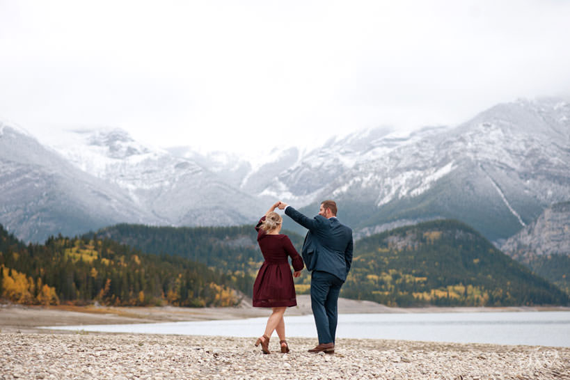 bride and groom dance on the shores of Barrier Lake captured by Calgary wedding photographer Tara Whittaker