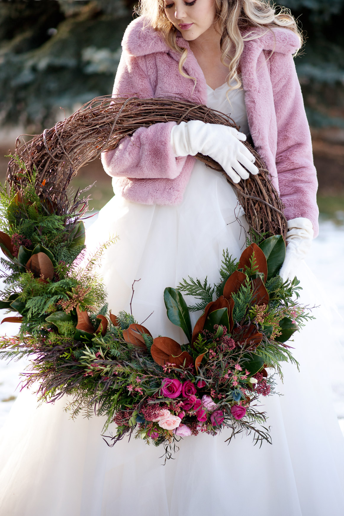 winter bride holding a wreath captured by one of the best wedding photographers in Calgary Tara Whittaker