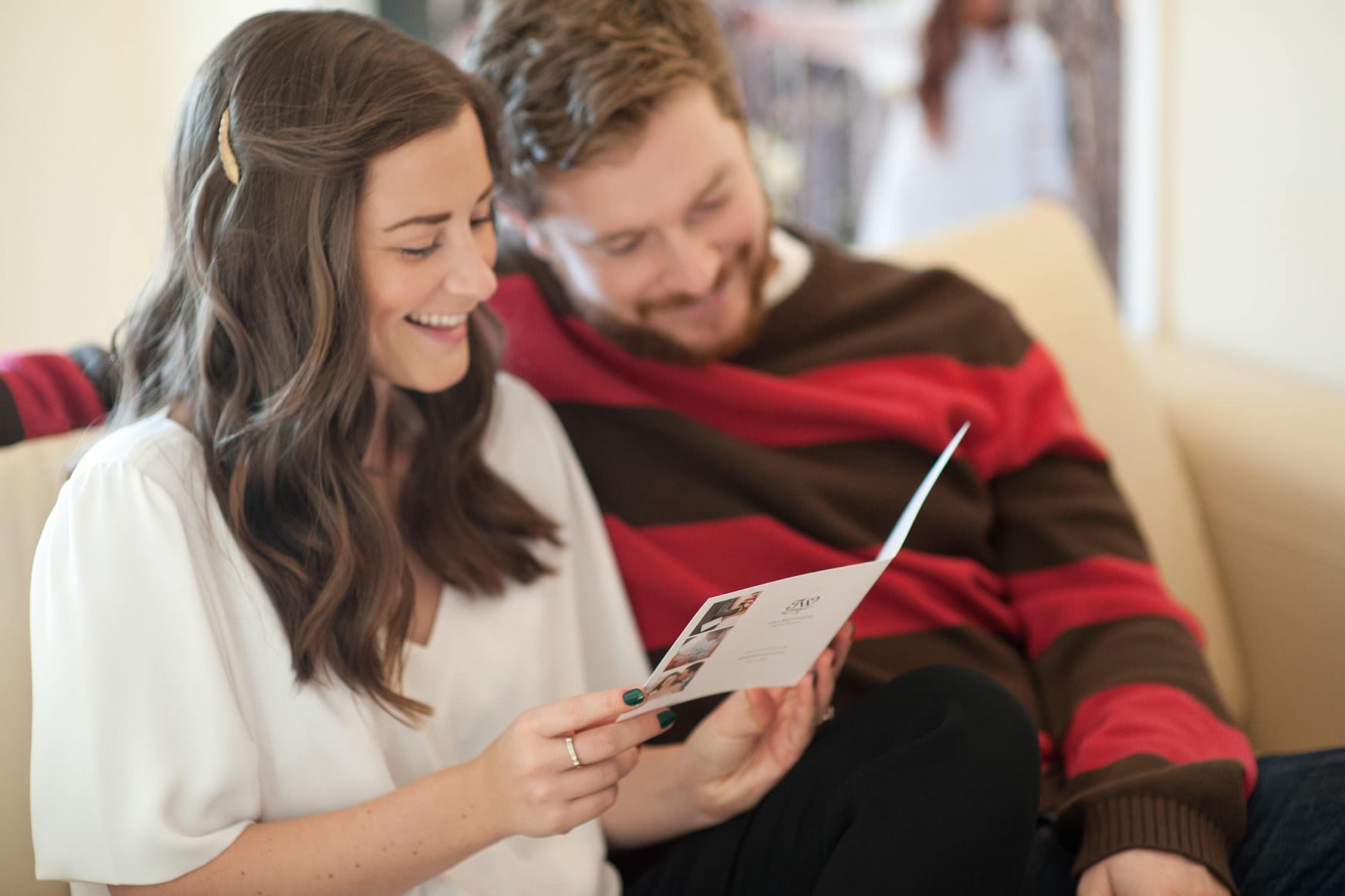 couple viewing price list for Calgary wedding photographer Tara Whittaker