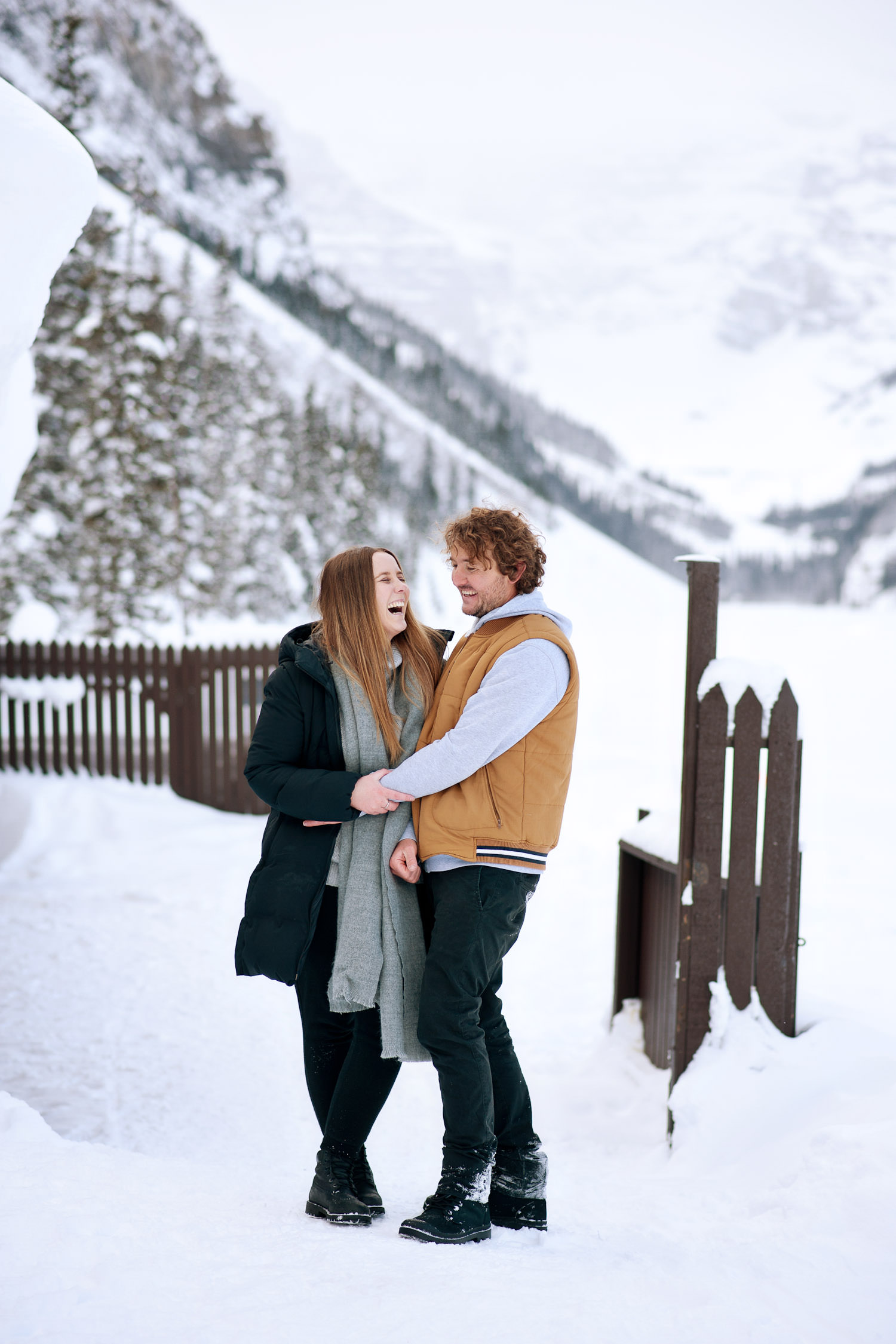 laughter during engagement session at Lake Louise captured by Tara Whittaker Photography