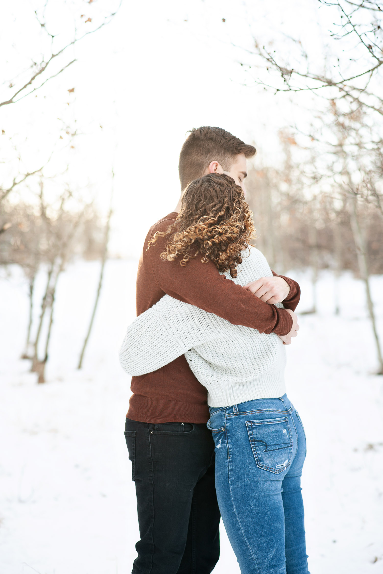 Hugs during their winter engagement session captured by Tara Whittaker Photography