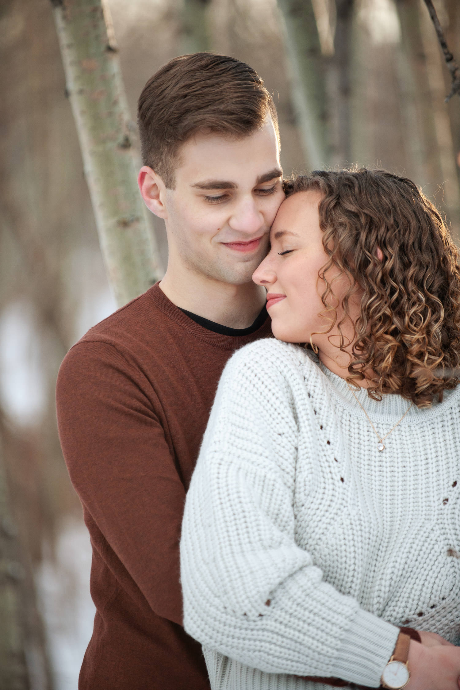 Sweet moment during winter engagement session at Edworthy Park captured by Tara Whittaker Photography