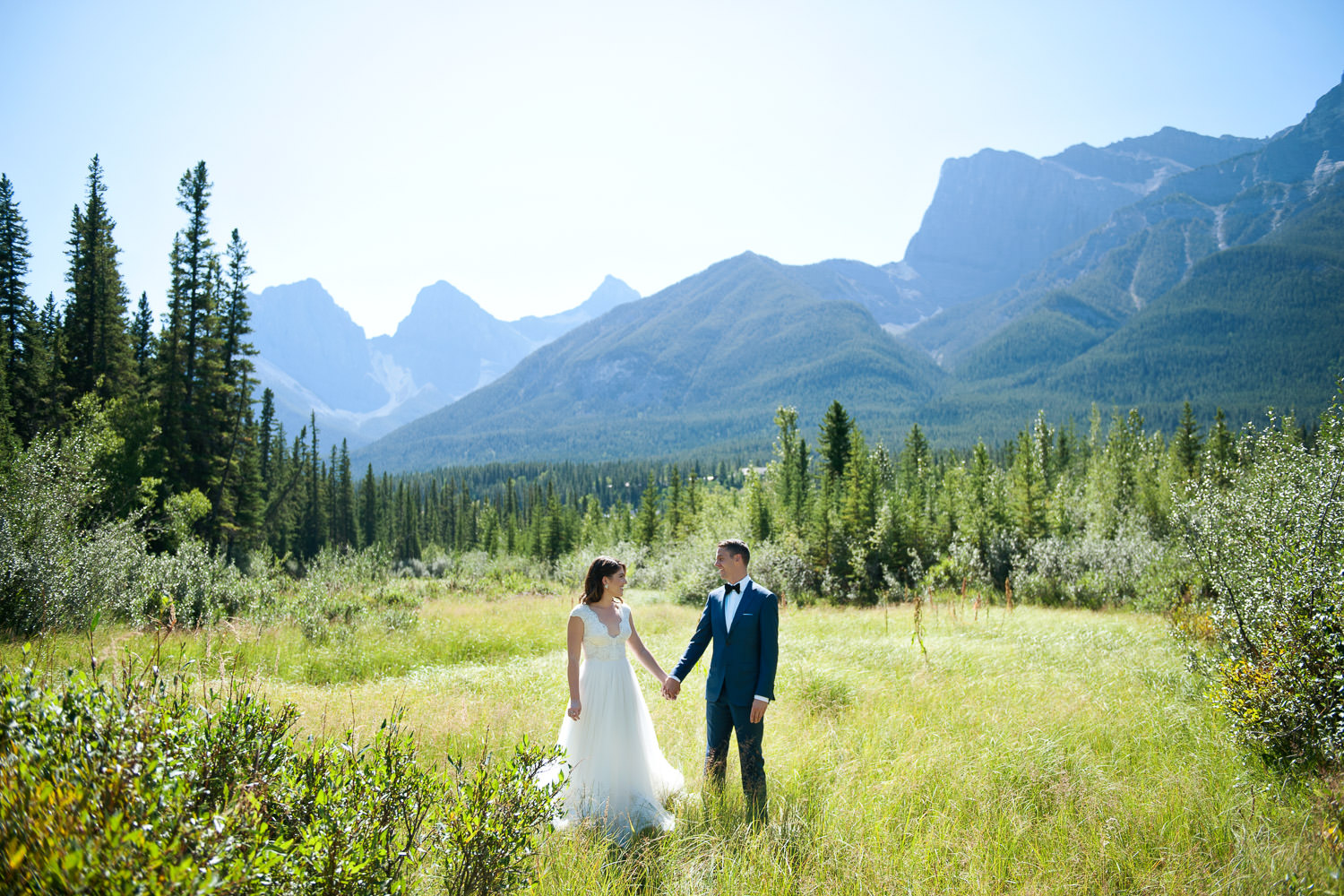 Bride and groom with the Three Sisters in Canmore captured by Tara Whittaker Photography