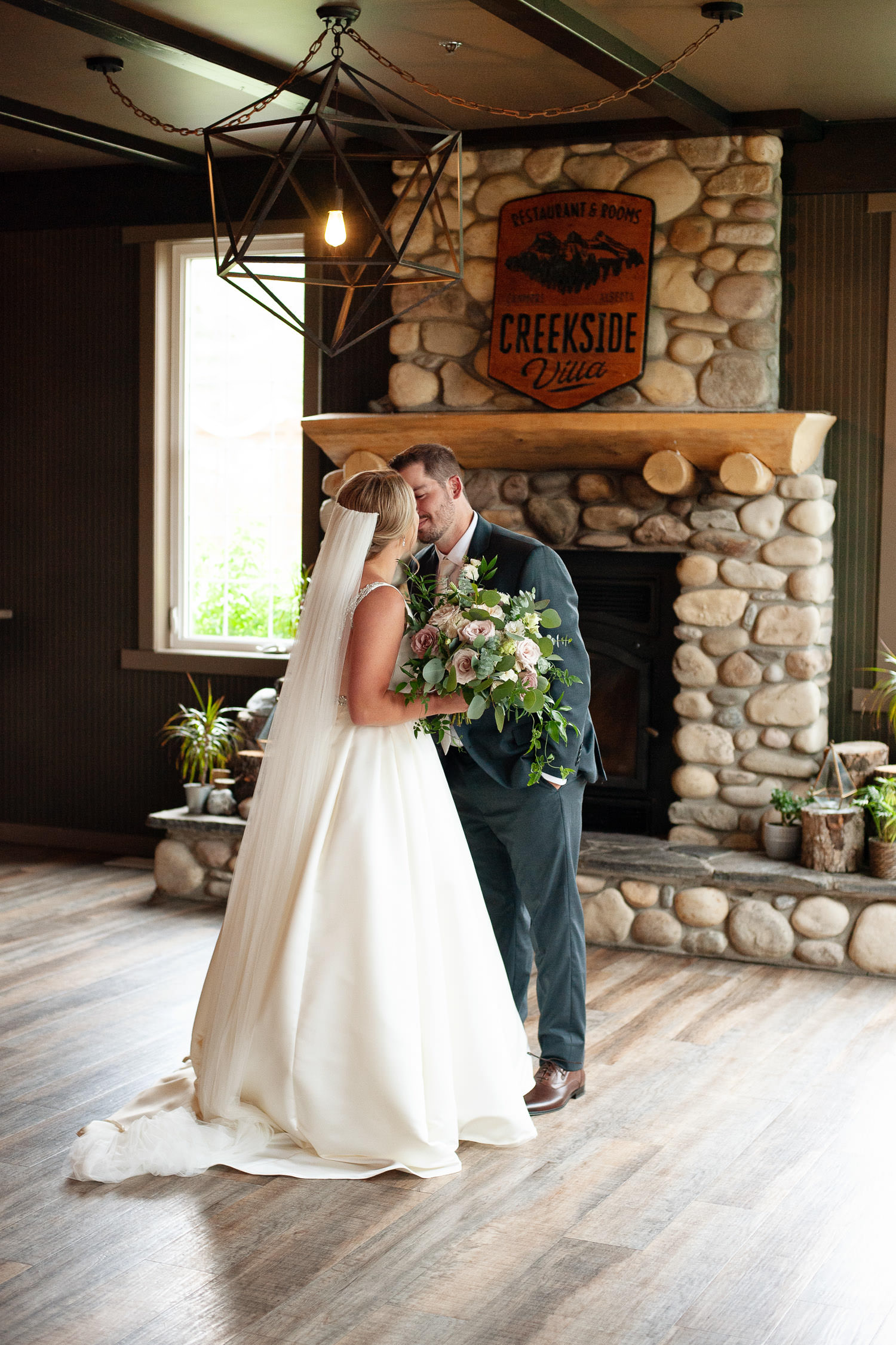 Bride and groom kiss during first look at Creekside Villa wedding captured by Tara Whittaker Photography