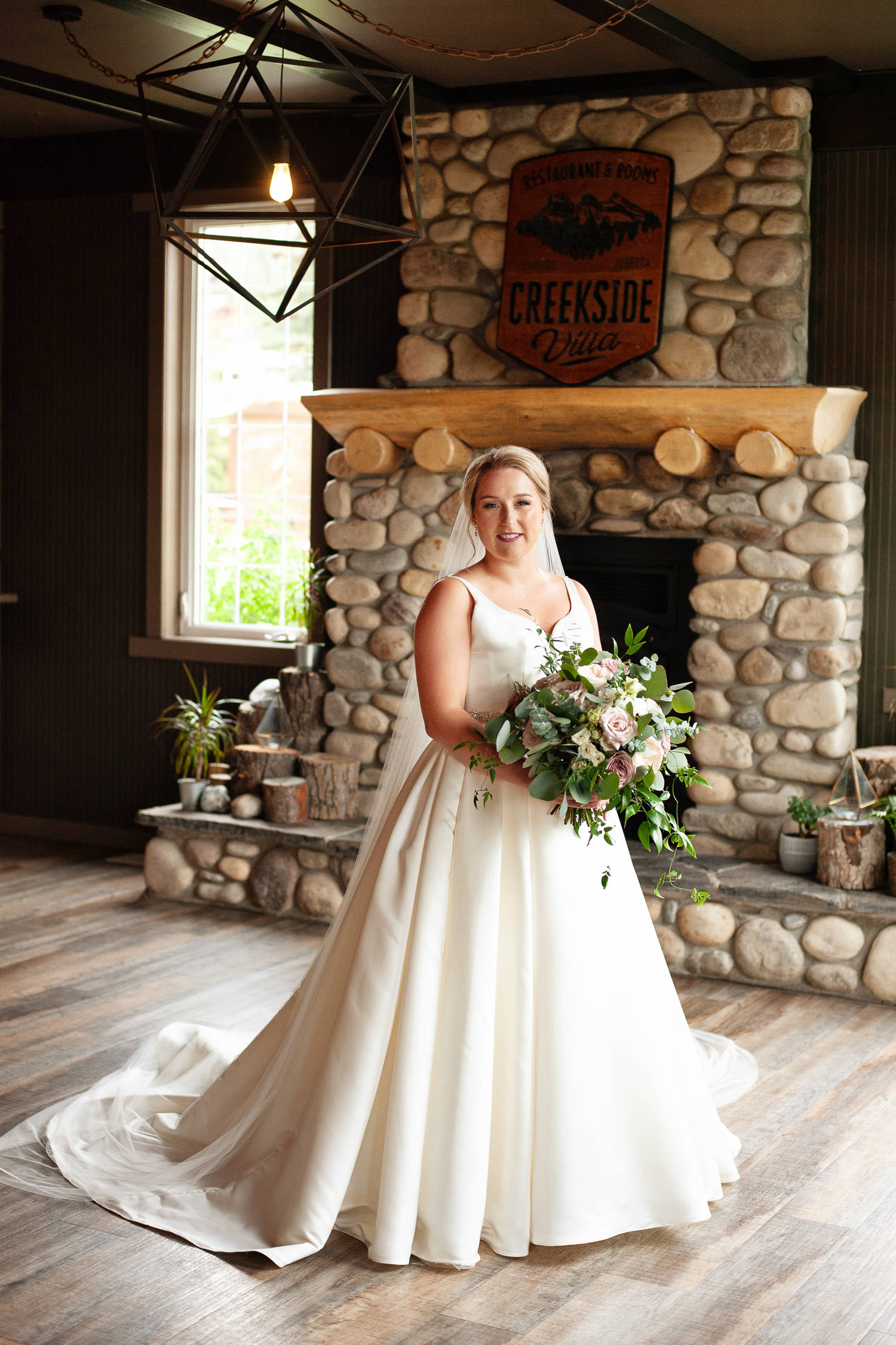 Bride poses at Creekside Villa in Canmore captured by Tara Whittaker Photography