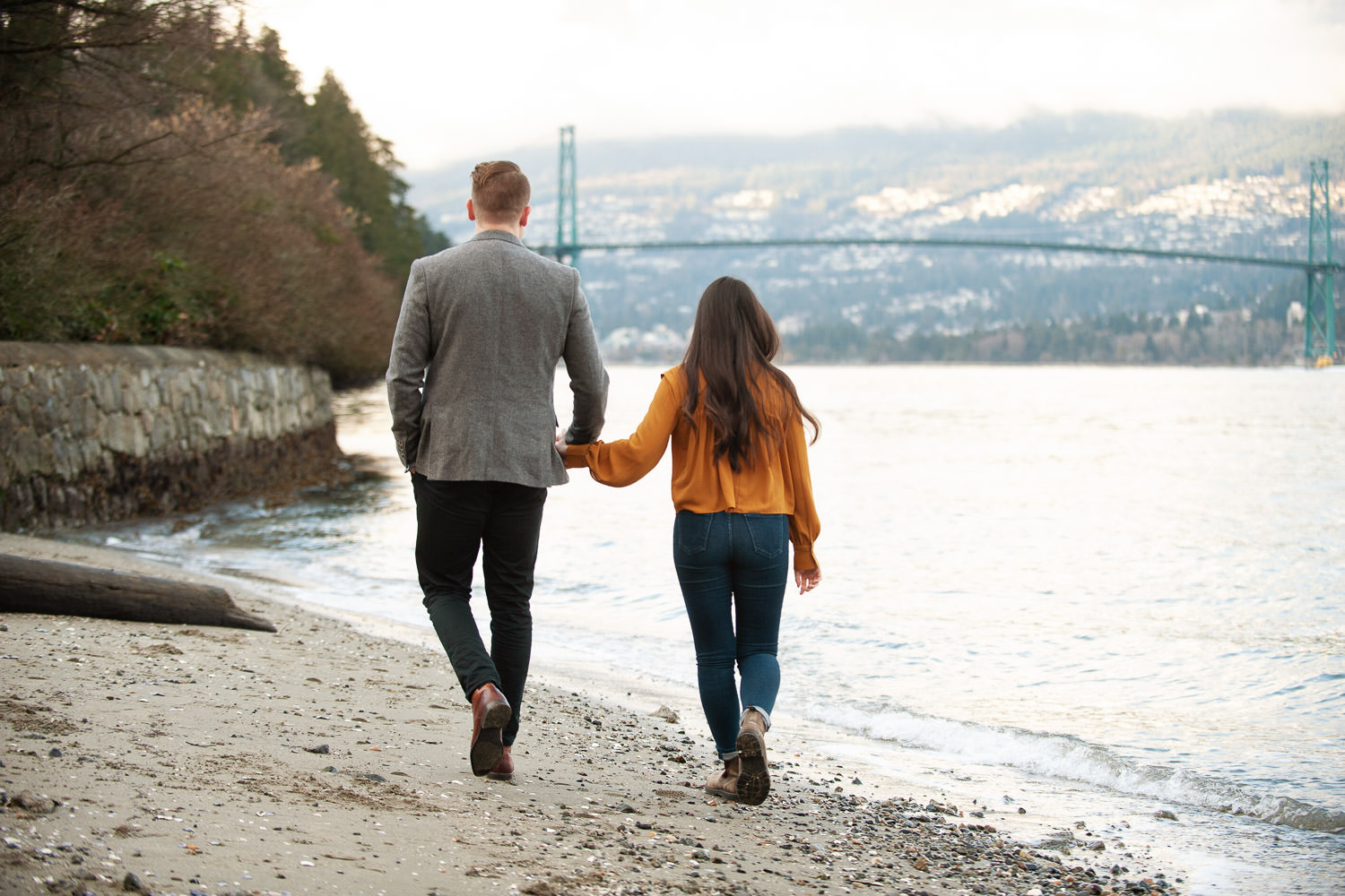 couple on beach with Lions Gate Bridge in background captured by Tara Whittaker Photography