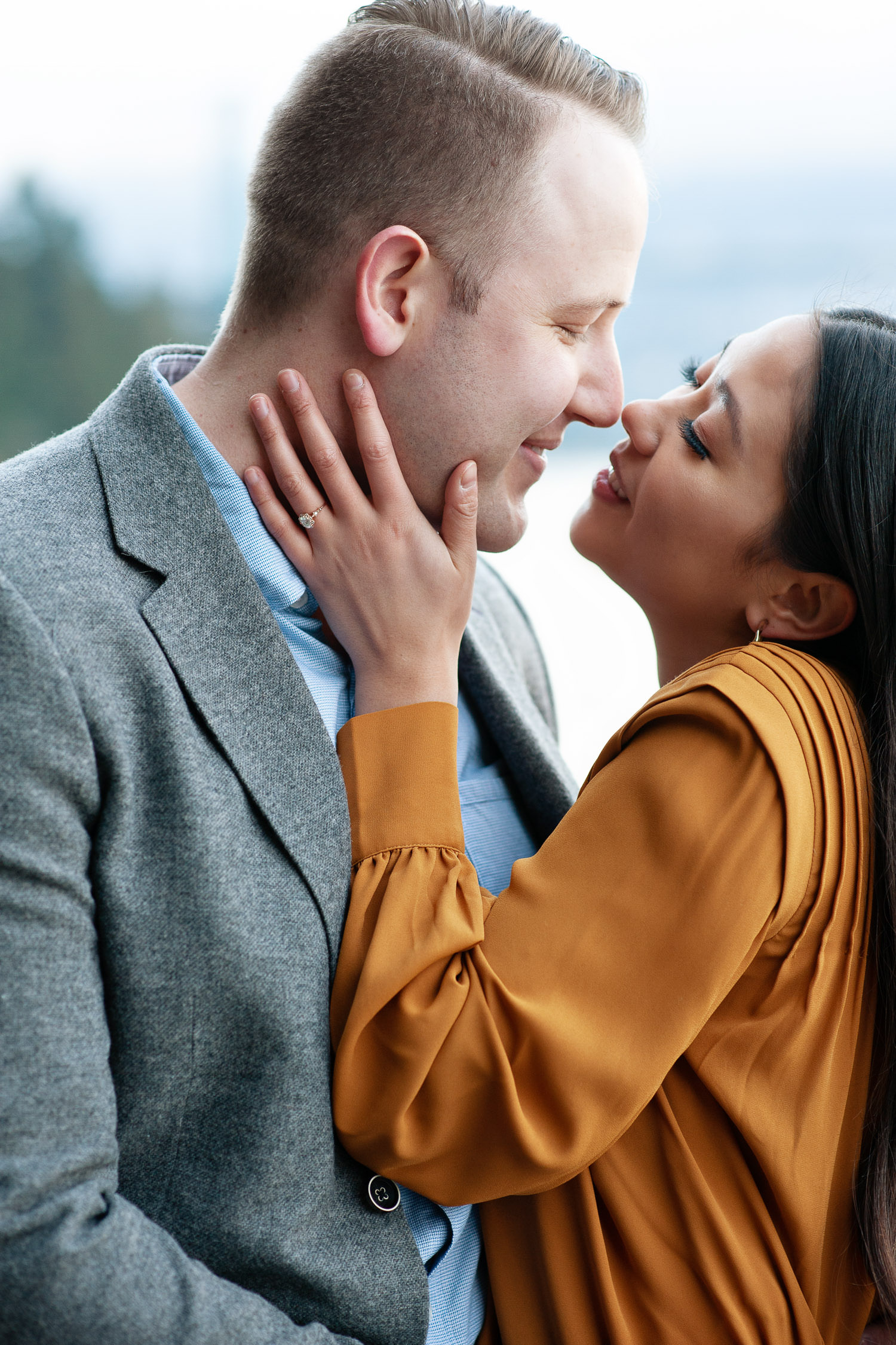 Couple kiss during engagement session on the Sea Wall in Vancouver captured by Tara Whittaker Photography