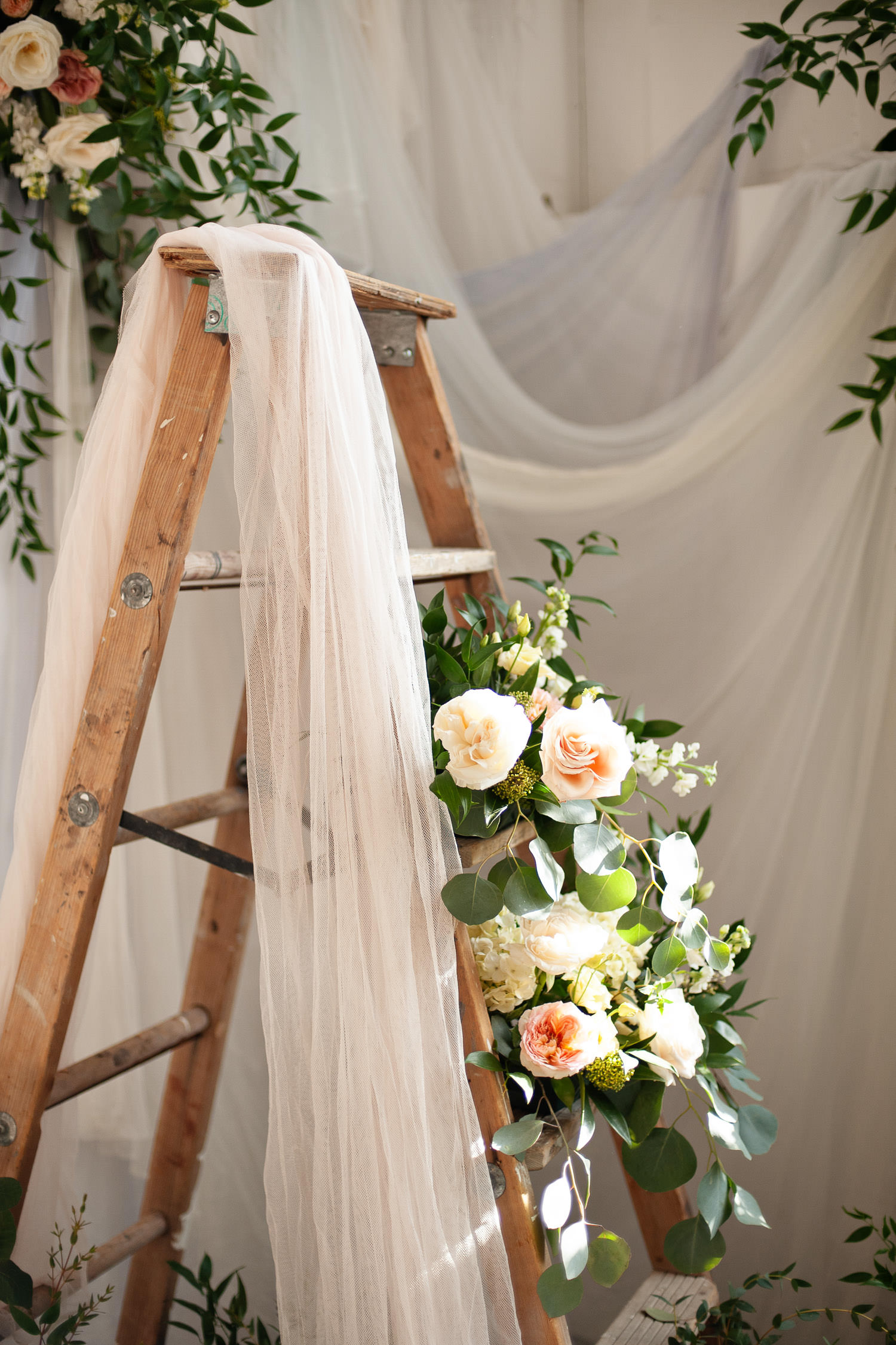 vintage ladder draped with textiles captured by Tara Whittaker Photography