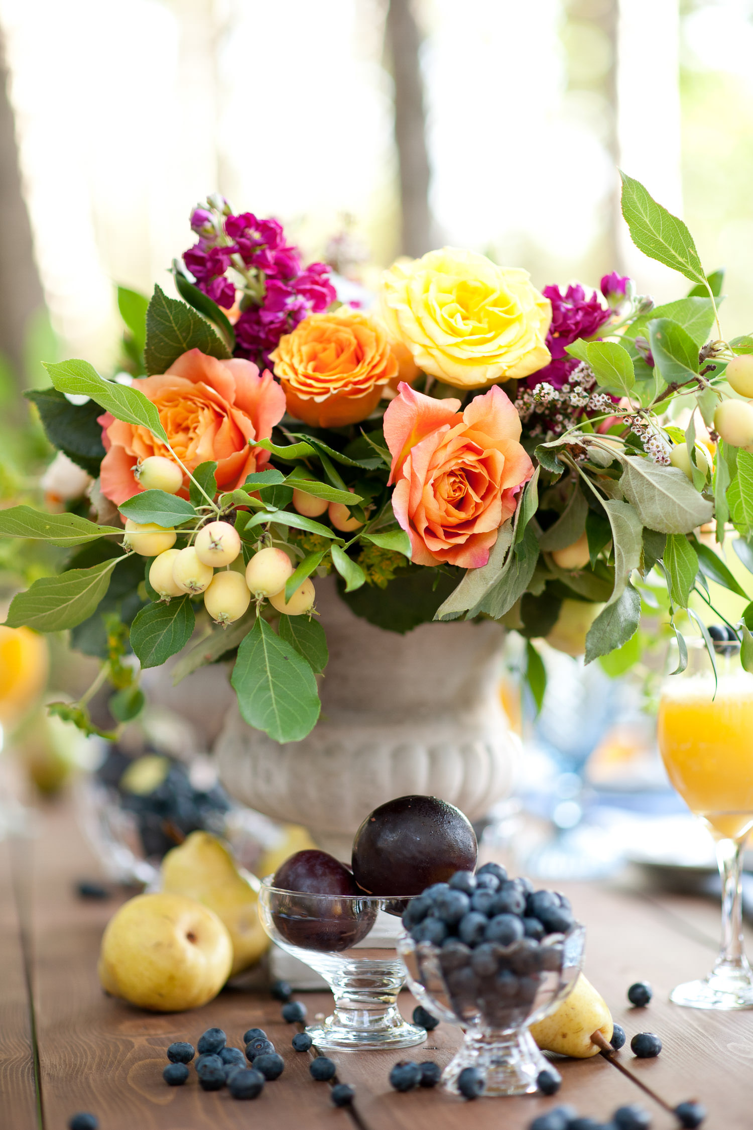 Plums, pears and blueberries on a brunch table captured by Tara Whittaker Photography